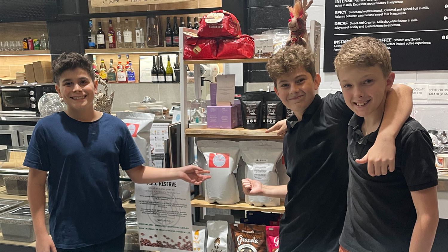 Photo of Arlee, Rocco and Cristiano standing next to their first bag of ARC Reserve coffee